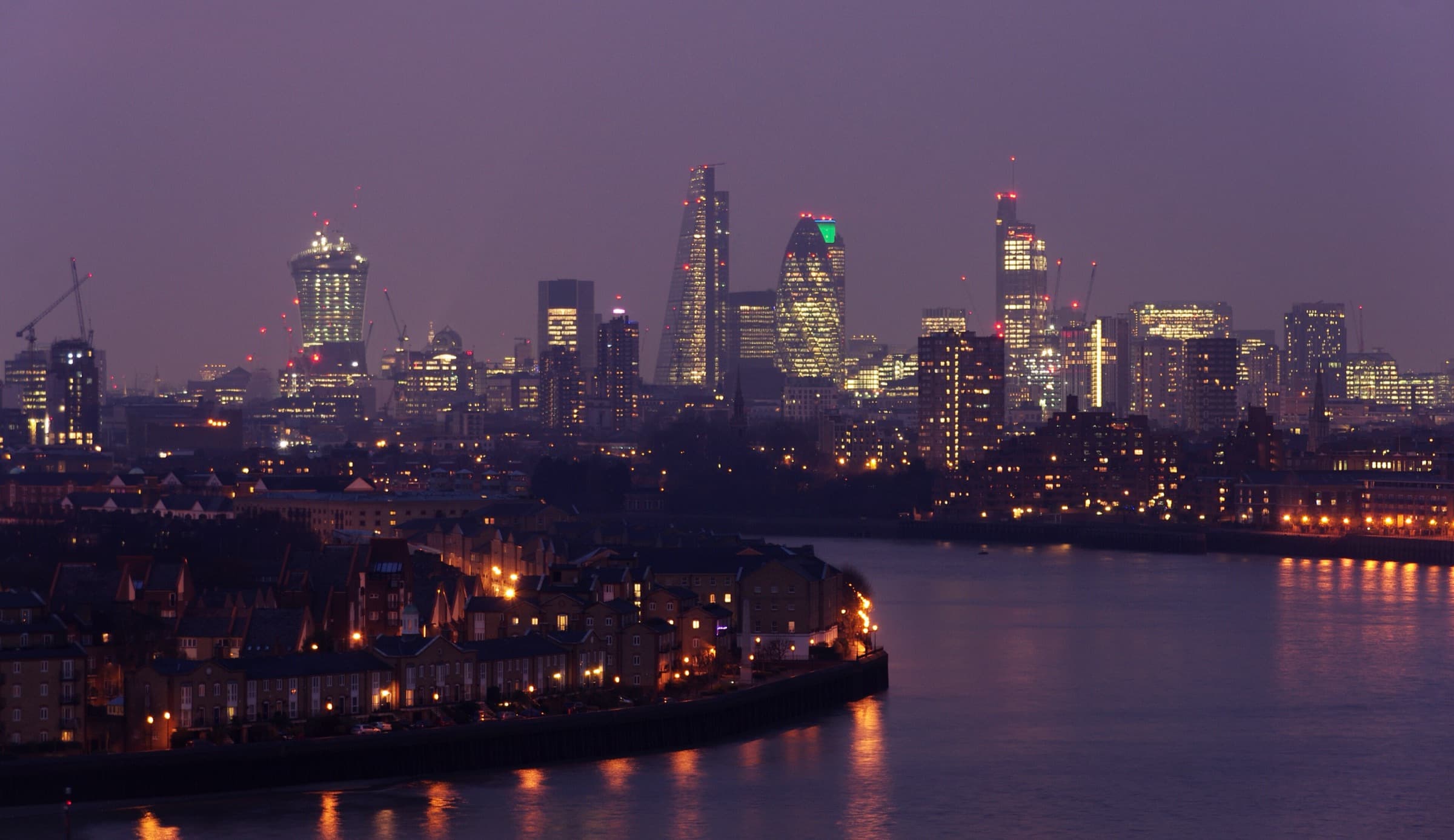 The City of London skyline across the River Thames at dusk